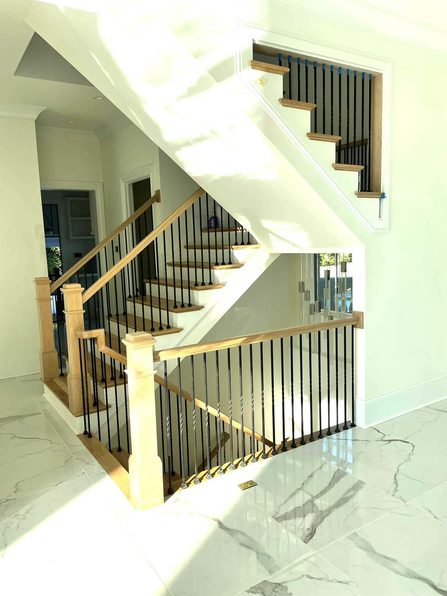 plain, black iron balusters with white oak handrails and newels