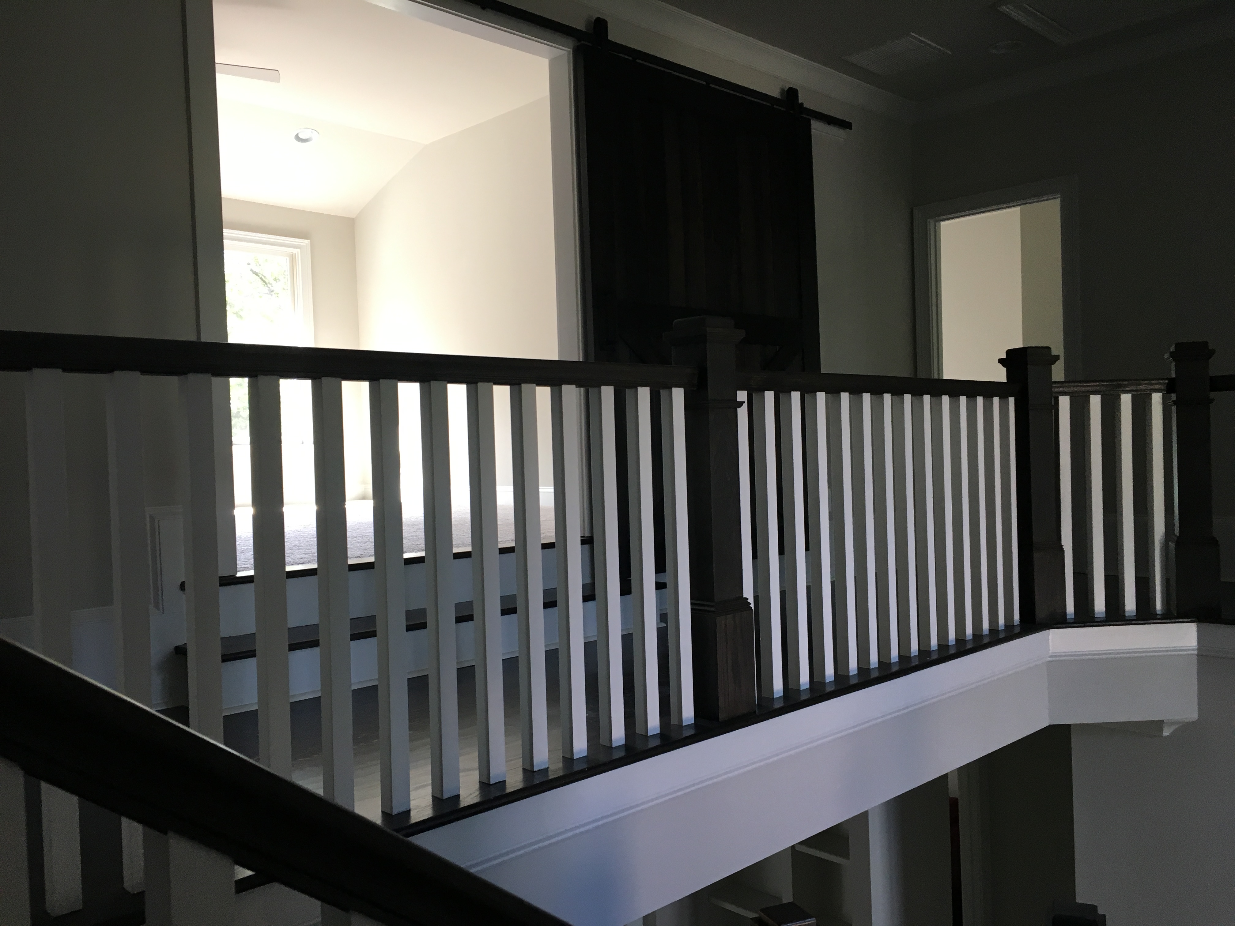 white square balusters with dark stained handrails and posts